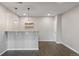 Open-concept living room with bar seating and modern pendant lighting at 15131 Munich Ave, Parker, CO 80134