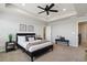 Main bedroom with a tray ceiling, ceiling fan, and neutral decor at 15131 Munich Ave, Parker, CO 80134