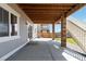 Covered patio with concrete flooring, stone pillars, and stairs leading to the backyard at 15131 Munich Ave, Parker, CO 80134