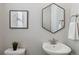 Stylish powder room featuring a modern sink, unique mirror, and contemporary decor at 15131 Munich Ave, Parker, CO 80134