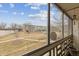 Enclosed balcony showcasing an outdoor view of lawn, buildings, and blue sky at 665 S Alton Way # 4B, Denver, CO 80247