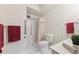 Cozy bathroom with a glass-enclosed shower, white tile, and floral wallpaper at 665 S Alton Way # 4B, Denver, CO 80247