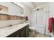 Well-lit bathroom featuring a bathtub-shower combo, vanity with cabinets, and decorative mirror at 665 S Alton Way # 4B, Denver, CO 80247