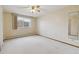 Bedroom features a ceiling fan, large window, and wallpaper, offering comfort and style at 665 S Alton Way # 4B, Denver, CO 80247