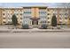 Inviting apartment building exterior featuring a well-maintained entrance and landscaped surroundings at 665 S Alton Way # 4B, Denver, CO 80247