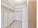 Walk-in closet with ample storage space, white shelving, and neutral carpeting at 665 S Alton Way # 4B, Denver, CO 80247