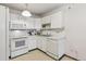 Cozy kitchen with white appliances and a functional layout at 665 S Alton Way # 4B, Denver, CO 80247