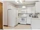 Bright kitchen featuring white appliances and plenty of cabinet space at 665 S Alton Way # 4B, Denver, CO 80247