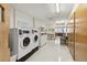 Well-lit laundry room with multiple washers and dryers for resident convenience at 665 S Alton Way # 4B, Denver, CO 80247