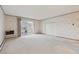 Open living room with sliding glass doors and neutral carpet at 665 S Alton Way # 4B, Denver, CO 80247