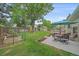 This backyard features a well-manicured lawn, patio area, mature trees, a storage shed and a charming garden at 8116 W Fremont Dr, Littleton, CO 80128
