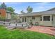 Charming backyard deck, stone patio, and mature trees for enjoying outdoor living at 8116 W Fremont Dr, Littleton, CO 80128