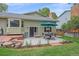 Spacious backyard with patio area features a dining table with a blue umbrella for relaxing in the sun at 8116 W Fremont Dr, Littleton, CO 80128