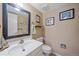Cozy bathroom features a modern sink, neutral walls, and decorative artwork at 8116 W Fremont Dr, Littleton, CO 80128