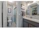 Modern bathroom features a glass shower, marble accents, and sleek gray vanity at 8116 W Fremont Dr, Littleton, CO 80128