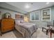 Charming bedroom features a comfortable bed, dresser, and ample natural light from the basement window at 8116 W Fremont Dr, Littleton, CO 80128