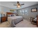 Spacious bedroom with a ceiling fan, plush carpet, and abundant natural light at 8116 W Fremont Dr, Littleton, CO 80128
