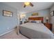 Relaxing bedroom with plush carpet, a ceiling fan, and an ensuite bathroom at 8116 W Fremont Dr, Littleton, CO 80128