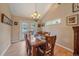 Dining room features hardwood floors, chandelier, and French doors leading to the backyard at 8116 W Fremont Dr, Littleton, CO 80128