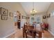 Dining room with hardwood floors, chandelier, and view into the kitchen at 8116 W Fremont Dr, Littleton, CO 80128