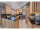 Open concept kitchen with granite countertops, an island with barstool seating, and stainless steel appliances at 8116 W Fremont Dr, Littleton, CO 80128
