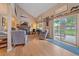 Cozy living room with vaulted ceilings, a fireplace, hardwood floors, and sliding glass door to the backyard at 8116 W Fremont Dr, Littleton, CO 80128