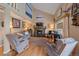 Inviting living room features a fireplace, vaulted ceilings, hardwood floors, and large windows for natural light at 8116 W Fremont Dr, Littleton, CO 80128