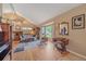 Bright living room featuring vaulted ceilings, hardwood floors, and a large window with outside views at 8116 W Fremont Dr, Littleton, CO 80128