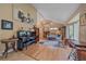 Cozy living room with a piano, vaulted ceilings, lots of natural light, and hardwood floors at 8116 W Fremont Dr, Littleton, CO 80128