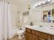 Functional bathroom with a tub-shower combination, clean vanity, well-lit mirror, and essential fixtures at 5995 W Hampden Ave # 17F, Denver, CO 80227
