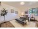 Cozy bedroom featuring a comfortable bed, stylish bench, decorative accents, and a large window for natural light at 5995 W Hampden Ave # 17F, Denver, CO 80227