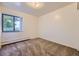 Simple bedroom with ample natural light from the window. The space is carpeted and has baseboard heating at 5995 W Hampden Ave # 17F, Denver, CO 80227