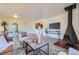 Inviting living room featuring a cone fireplace, plush seating, stylish decor, and open access to the dining area at 5995 W Hampden Ave # 17F, Denver, CO 80227