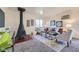 Cozy living room with rustic decor, including a striking cone fireplace, comfortable seating, and decorative wall art at 5995 W Hampden Ave # 17F, Denver, CO 80227