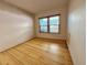 Bright bedroom features hardwood floors and a window with natural light at 267 S 3Rd Ave, Brighton, CO 80601
