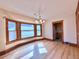 Sunlit dining room with bay windows and hardwood floors, adjacent to the kitchen at 267 S 3Rd Ave, Brighton, CO 80601