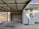 Attached carport and garage seen from the side yard of the property at 267 S 3Rd Ave, Brighton, CO 80601