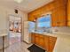 Cozy kitchen featuring wood cabinets, a white refrigerator, and tiled countertops at 267 S 3Rd Ave, Brighton, CO 80601