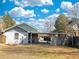 Backyard showcasing the property's exterior, including the parking area and fencing at 267 S 3Rd Ave, Brighton, CO 80601