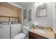 Well-lit bathroom with a granite countertop, modern fixtures and a laundry area at 1250 S Monaco Pkwy # 50, Denver, CO 80224