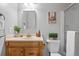 Bathroom with a vanity and mirror with the toilet and shower in the background at 1250 S Monaco Pkwy # 50, Denver, CO 80224