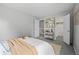 Cozy bedroom with stylish decor, featuring a white comforter and an open closet at 1250 S Monaco Pkwy # 50, Denver, CO 80224