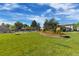 Expansive green space with a manicured lawn, colorful flower beds, and glimpses of nearby buildings and amenities at 1250 S Monaco Pkwy # 50, Denver, CO 80224