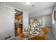 Dining area with a glass table and views of the kitchen and living room at 1250 S Monaco Pkwy # 50, Denver, CO 80224