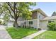 Charming two-story home with green lawn, mature tree, and convenient sidewalk access on a sunny day at 1250 S Monaco Pkwy # 50, Denver, CO 80224