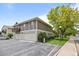 Exterior view features a well-maintained two-story home with a two-car garage and ample parking at 1250 S Monaco Pkwy # 50, Denver, CO 80224