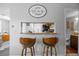 View of the kitchen bar with stools and a serving window at 1250 S Monaco Pkwy # 50, Denver, CO 80224