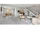Open living space featuring a dining area, breakfast bar, and comfortable seating arrangement near the staircase at 1250 S Monaco Pkwy # 50, Denver, CO 80224
