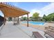 Community pool area features a wooden pergola, lounge chairs, and well-maintained surroundings at 1250 S Monaco Pkwy # 50, Denver, CO 80224