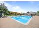 Community pool area featuring clear blue water, lounge chairs, and a wooden pergola for shade at 1250 S Monaco Pkwy # 50, Denver, CO 80224